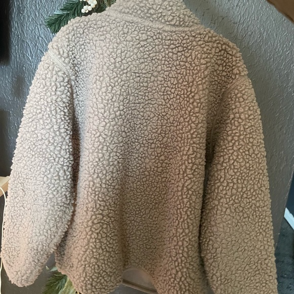A warm unisex tan-ish brown pullover sweater with two front zipper pockets. - Picture 2 of 4